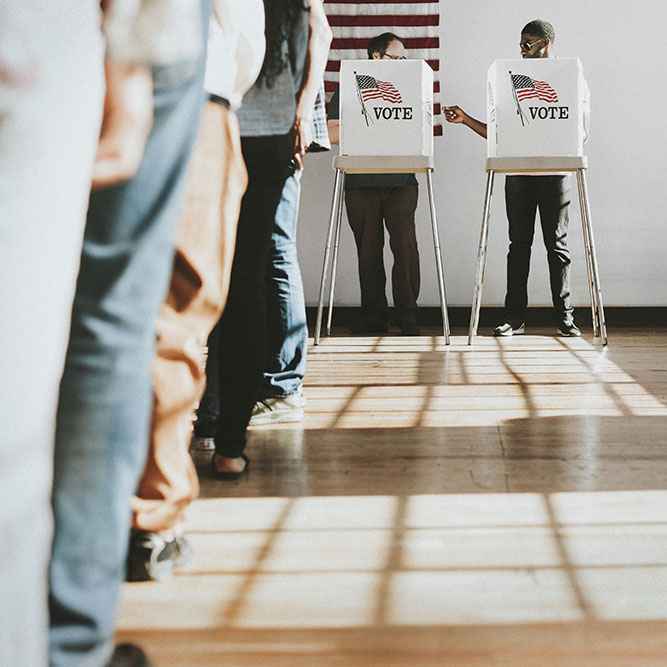 Americans standing in line waiting to vote for the presidential election.